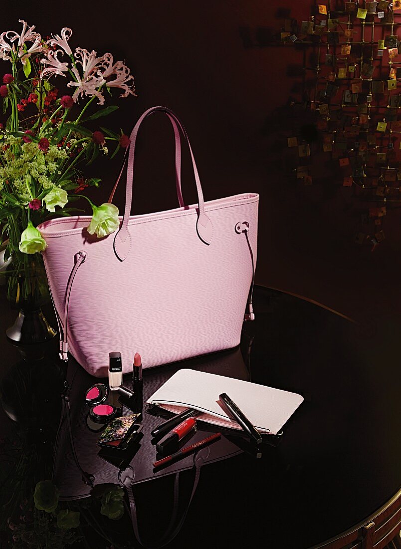 A pink shopping bag and make up