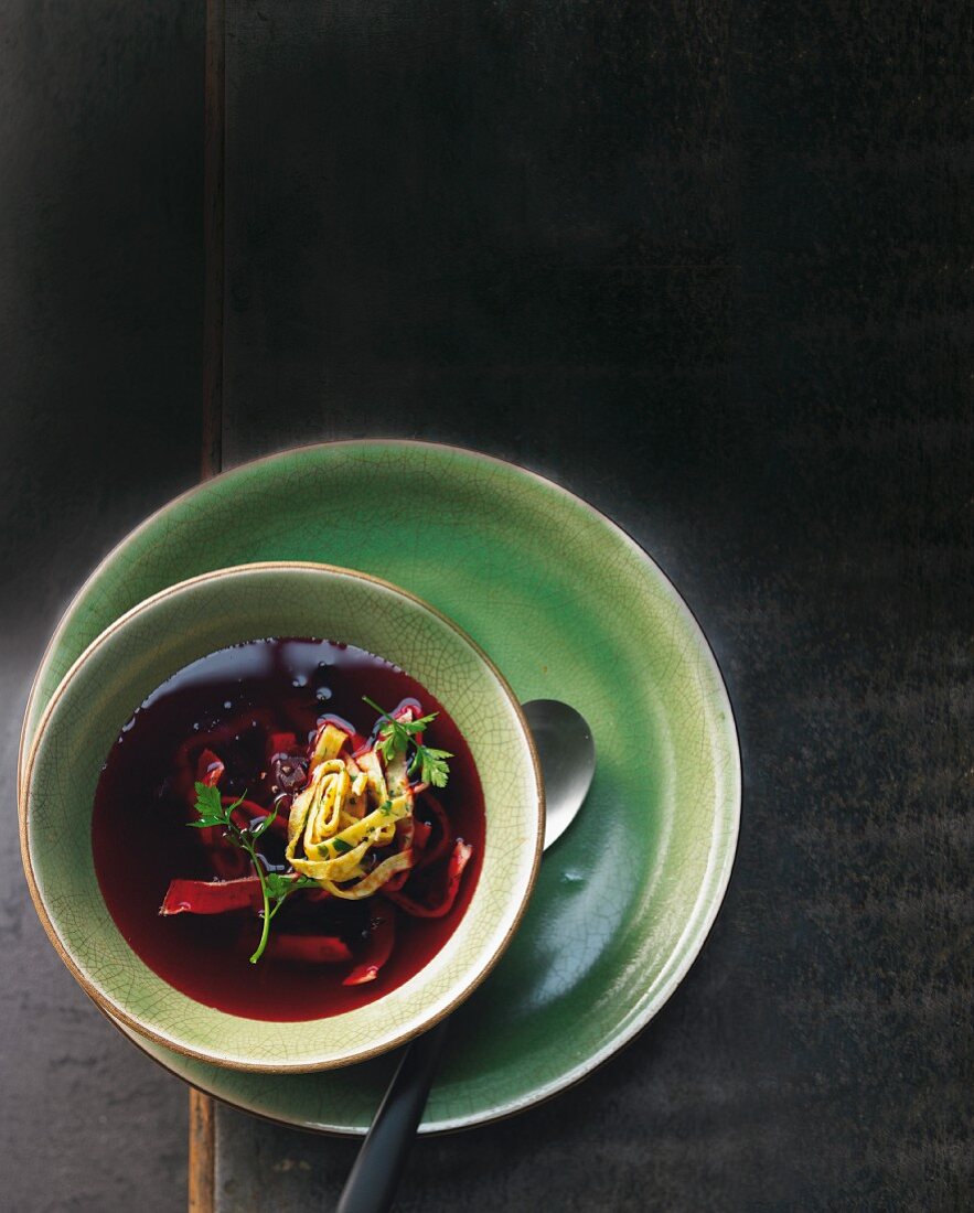 Beetroot and lemongrass broth with herb pancakes