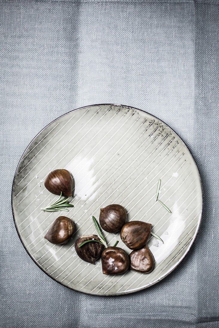 Chestnuts and rosemary on a plate
