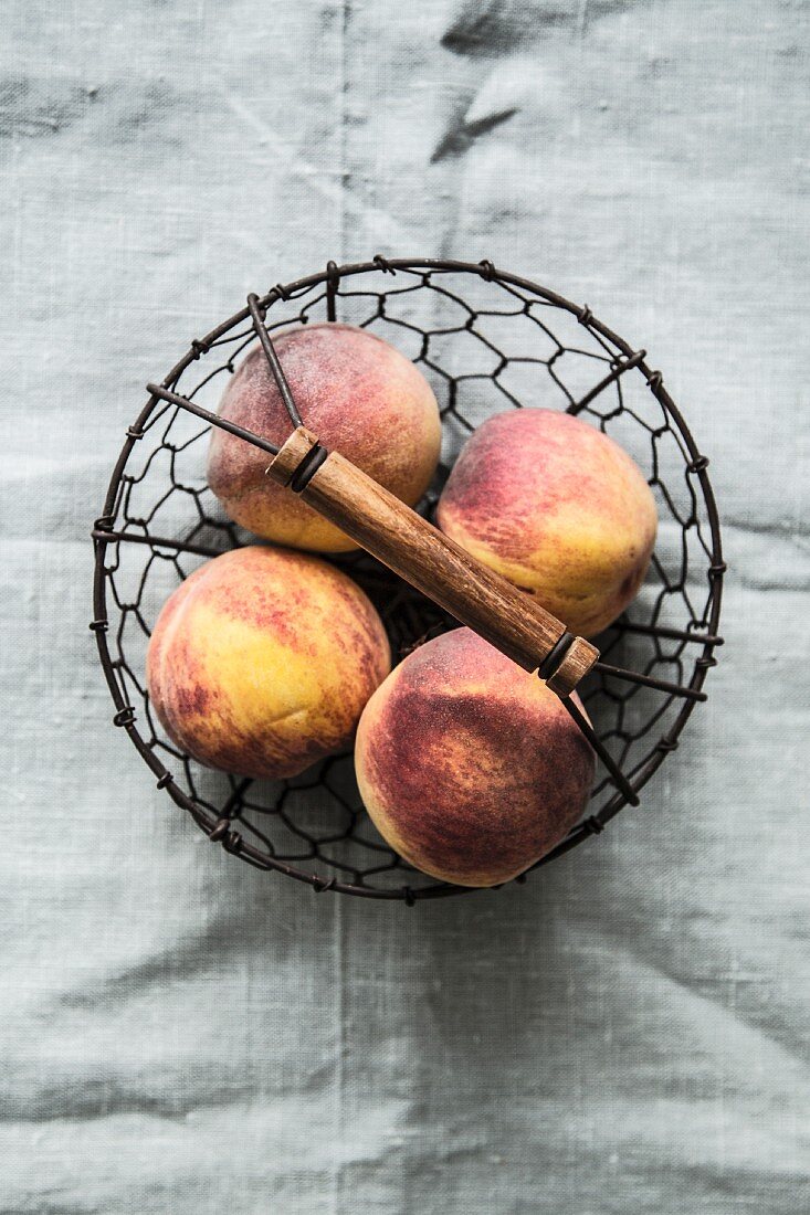 Peaches in a wire basket