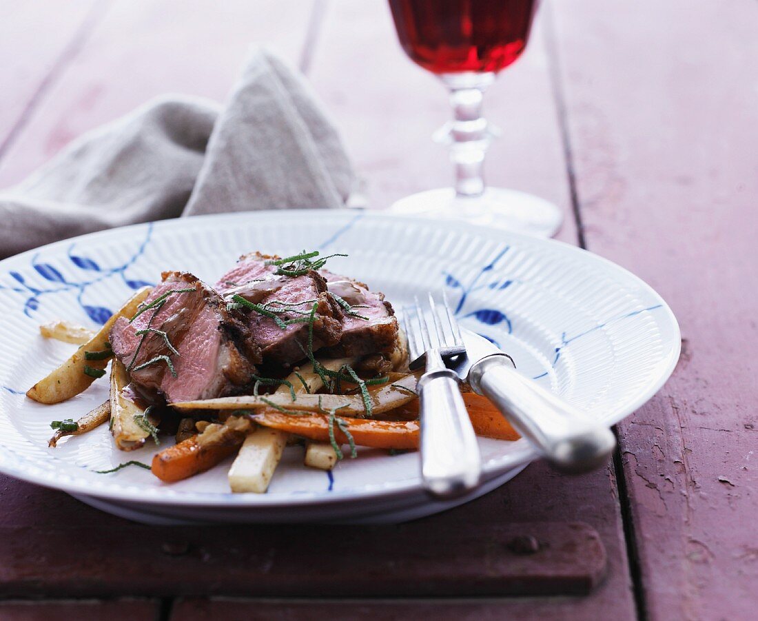 Duck breast on a bed of roasted root vegetables