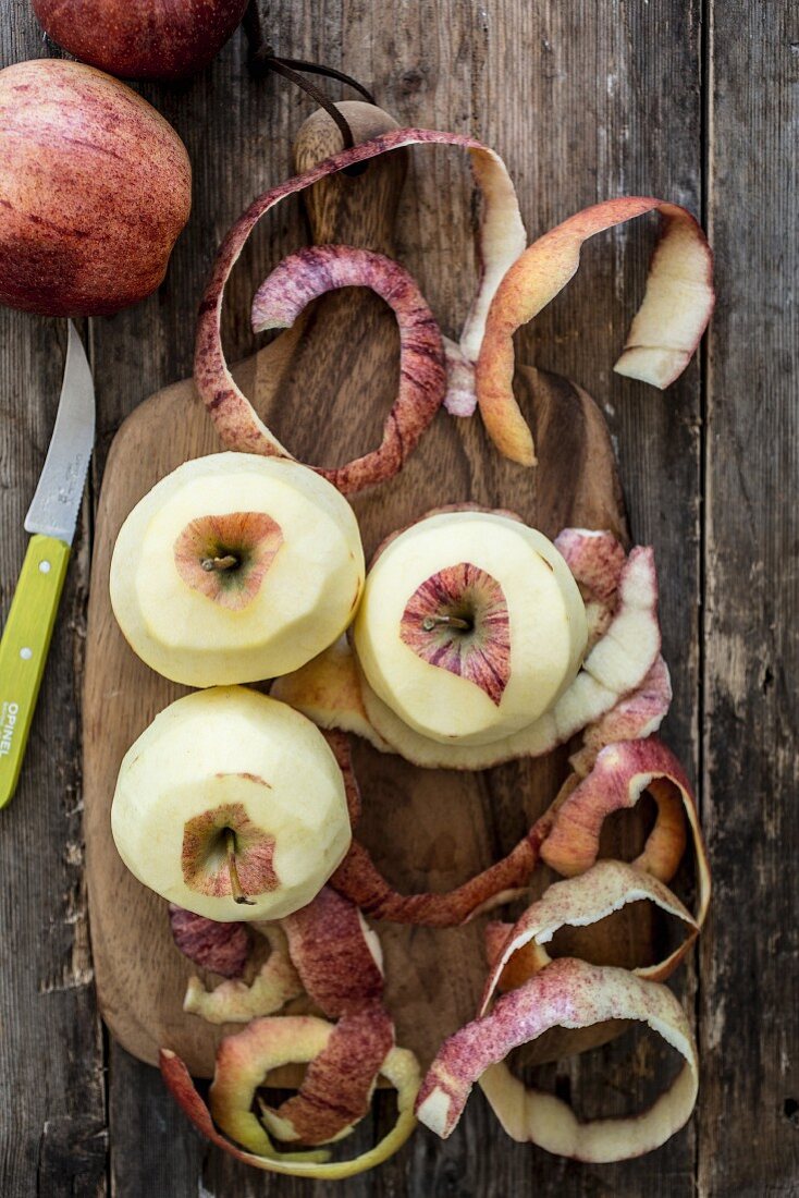 Peeled red apples on a chopping board