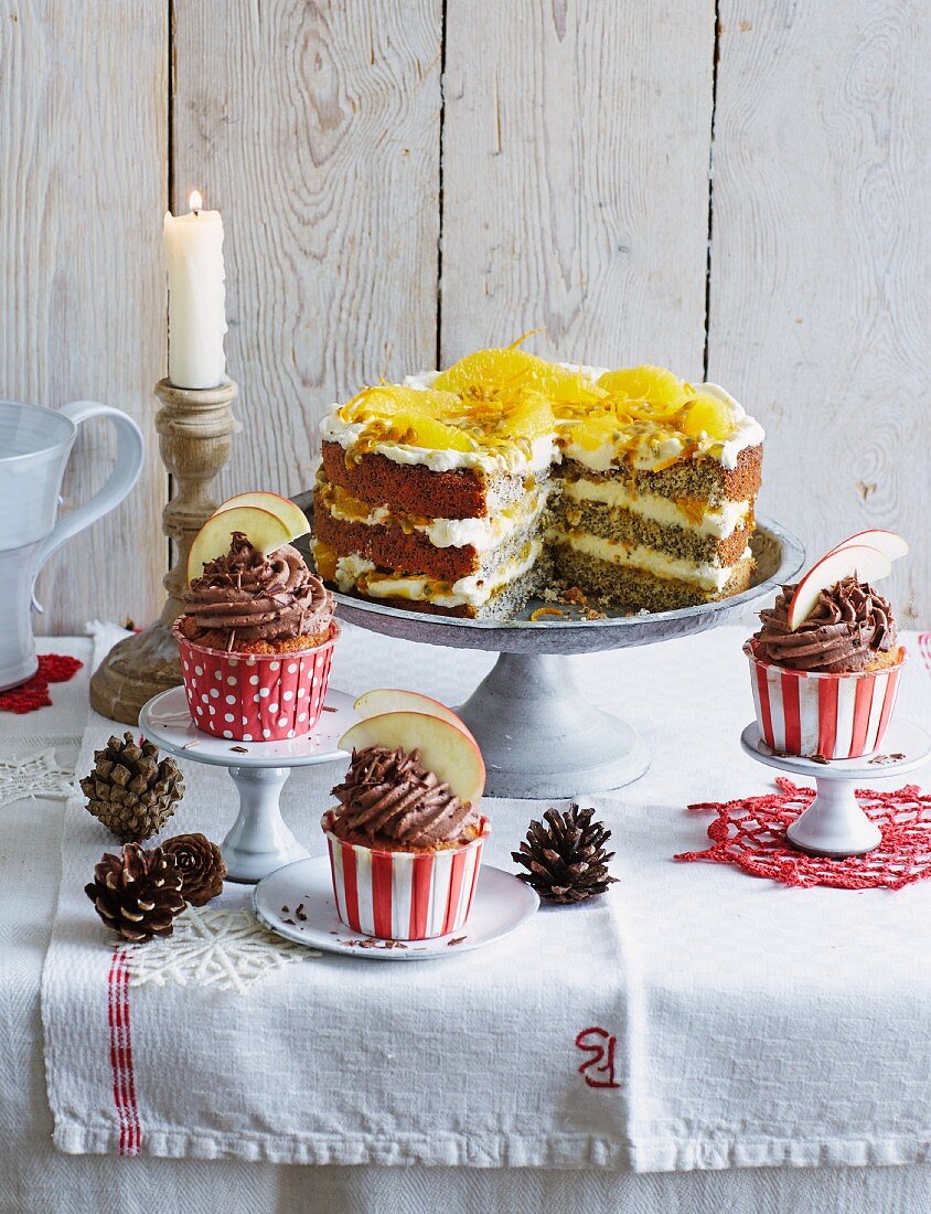 Baked apple cupcakes and orange and poppyseed cake, sliced (Christmas)