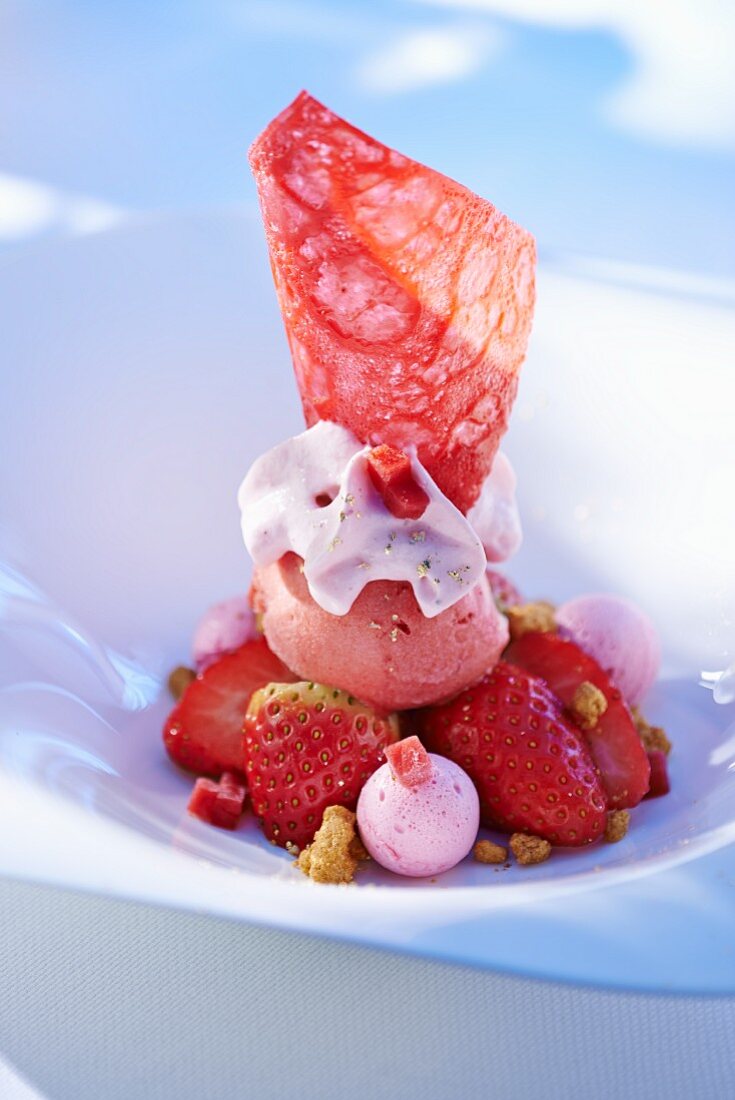 Strawberry dessert with fresh fruit, ice cream and strawberry cream