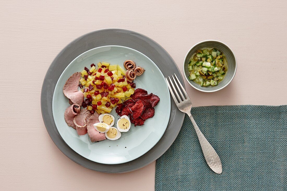 Labskaus (traditional dish from Northern Germany featuring salted meat, potatoes and onions) with roast beef