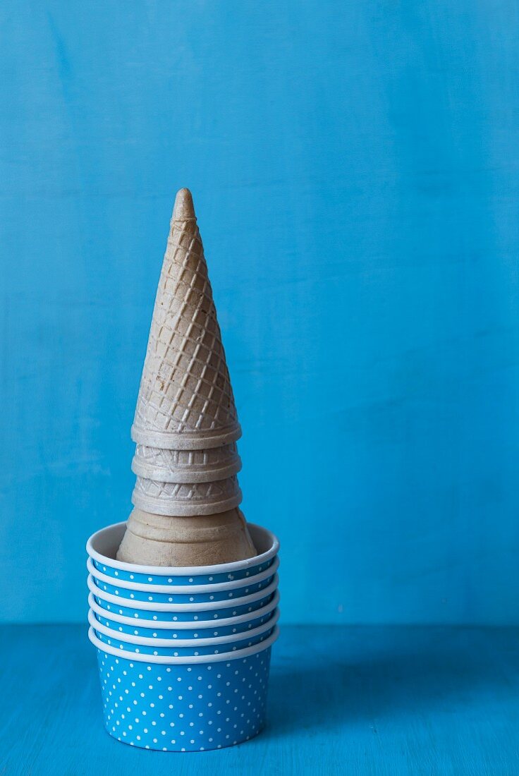 A stack of ice cream cones and paper cup