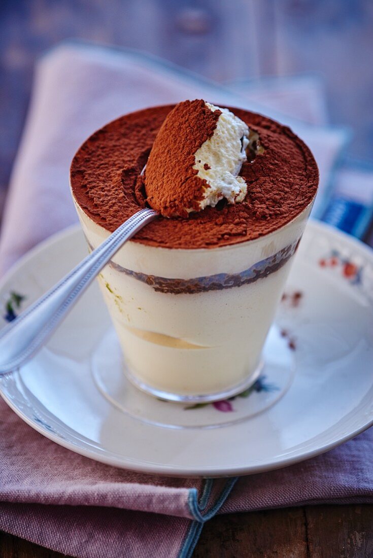 Tiramisu in a glass with a spoon