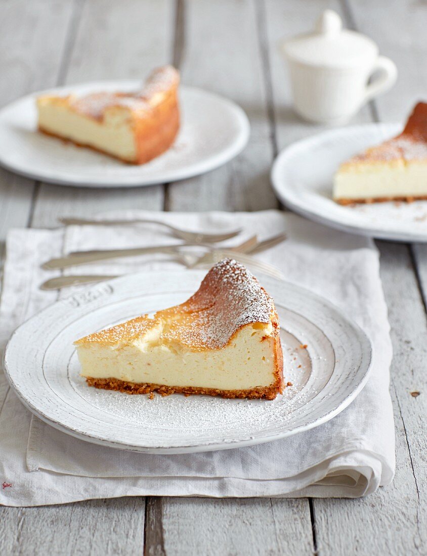 Three slices of cheesecake on plates