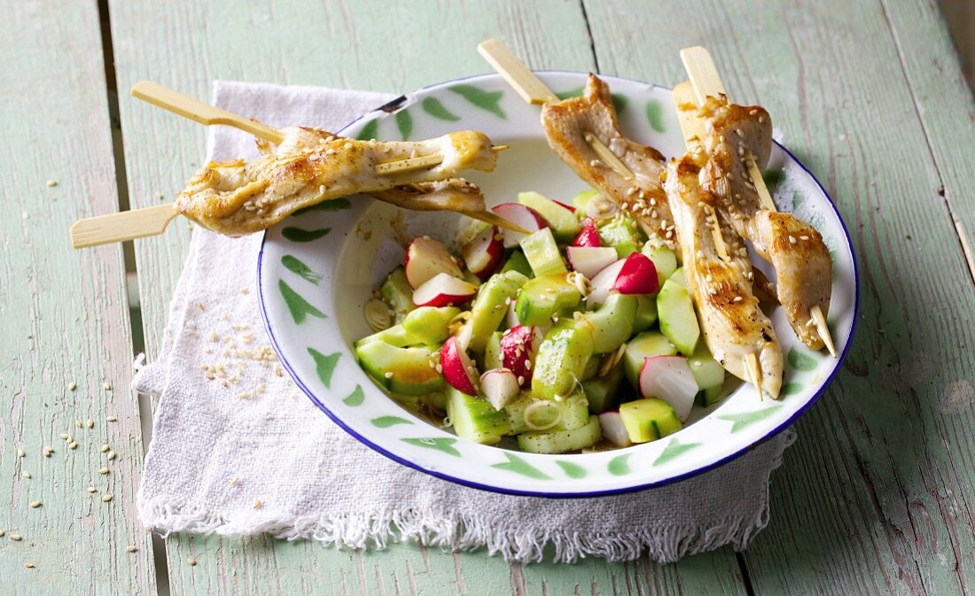 Chicken sate skewers with a cucumber and chilli salad