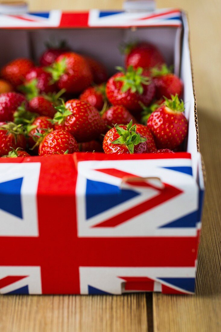 Fresh British strawberries in a box on a wooden table