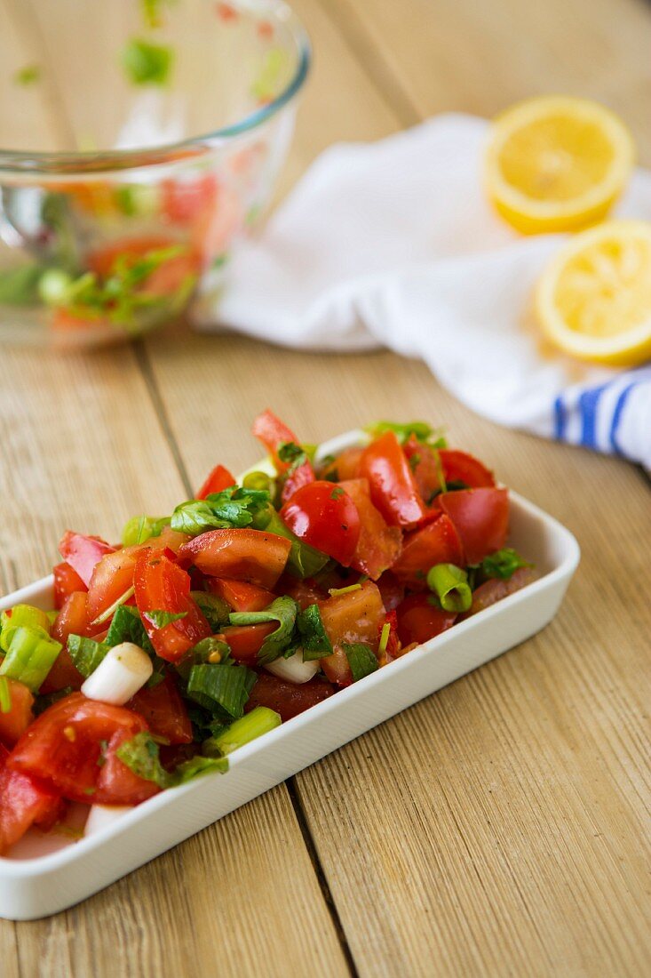 Fresh tomato salad with spring onions and a lemon dressing