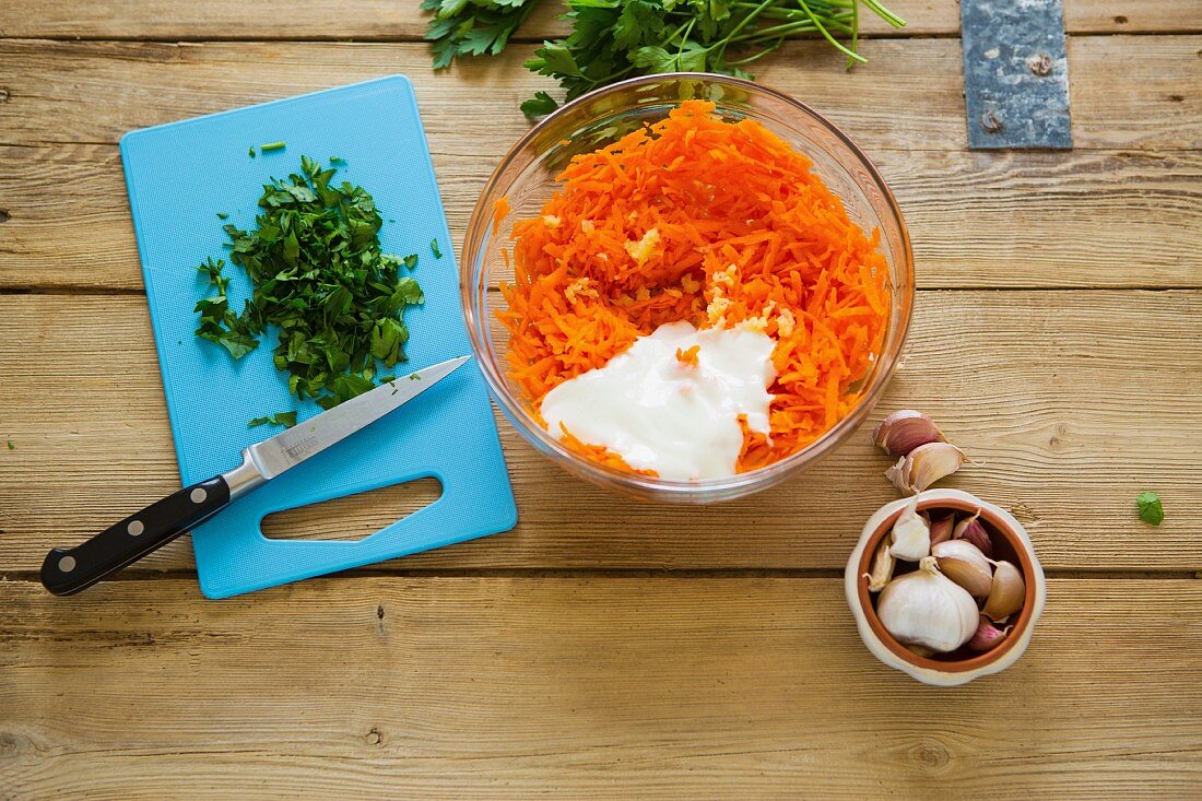 Ingredients for Turkish carrot salad on a rustic wooden table