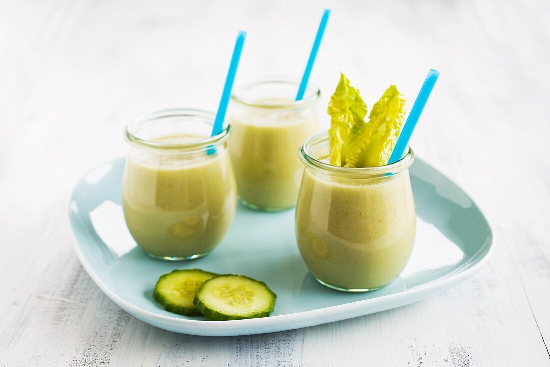 Vegetable smoothies in glasses with straws