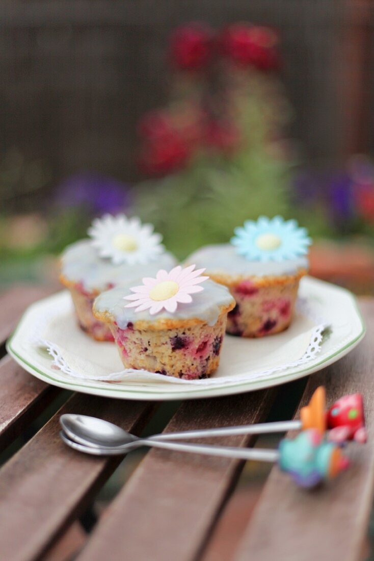 Spring cupcakes with berries and flower decorations