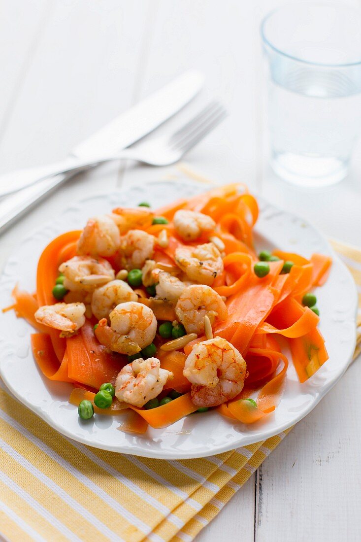 Carrot tagliatelle with prawns, peas and pine nuts