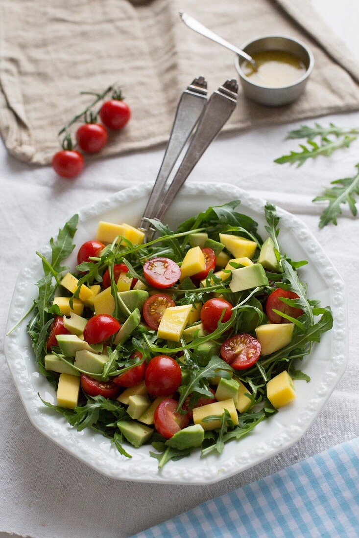 Mango and avocado salad with cherry tomatoes and rocket