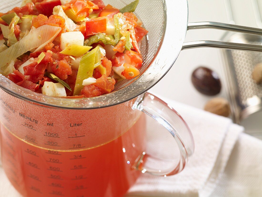 Tomato broth in a measuring jug