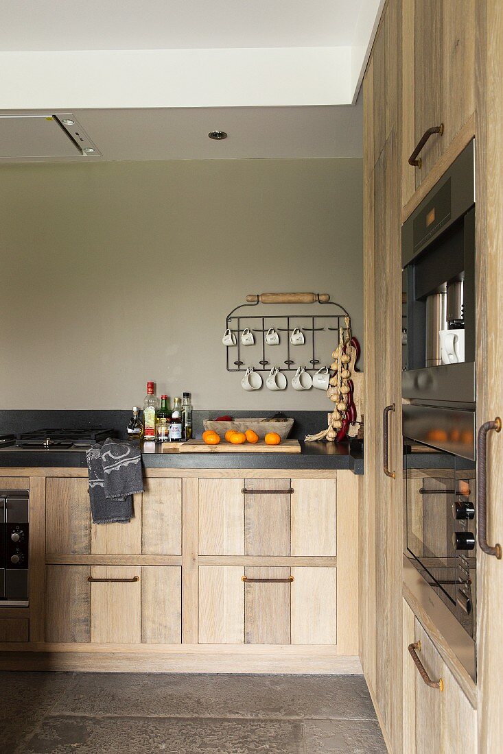 Fitted kitchen with solid-wood doors and taupe wall