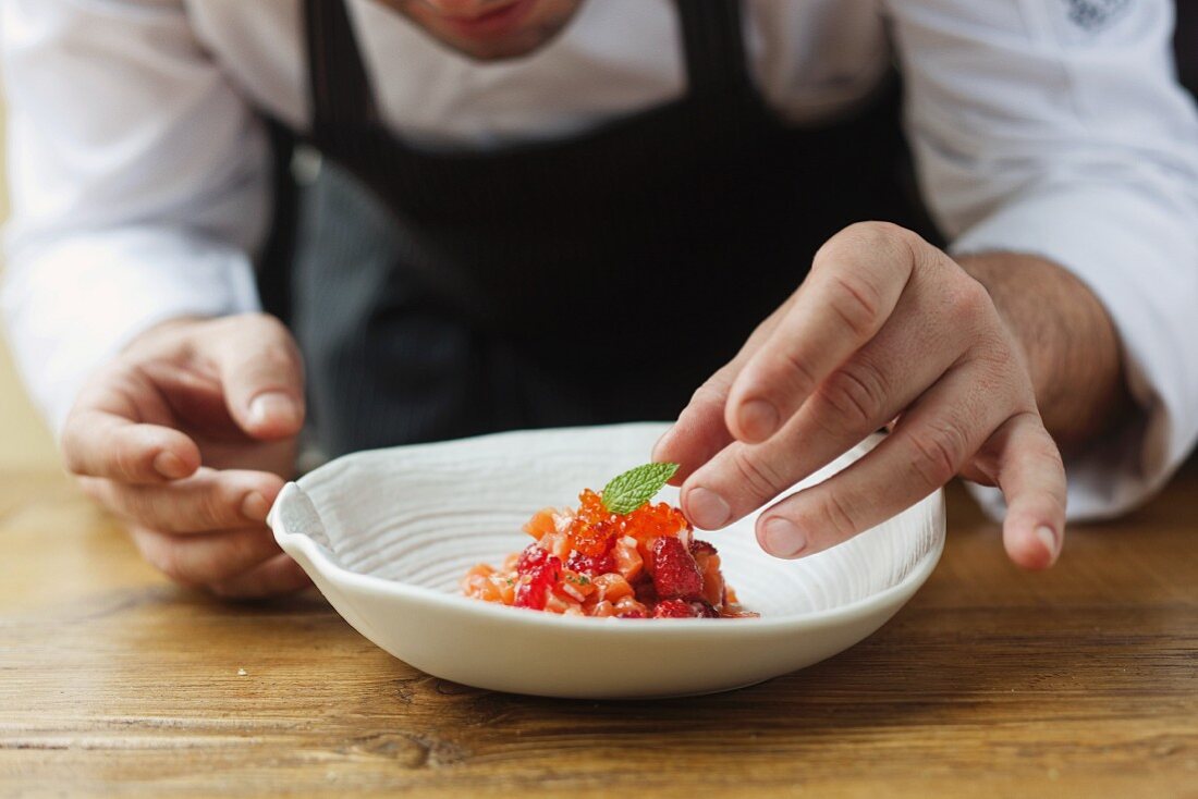 Salmon tartar with caviar, ginger, forest fruits and mint