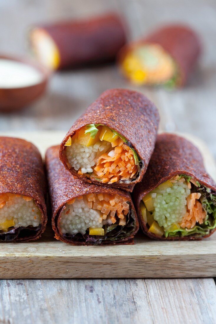 Vegetable-filled wraps on a chopping board