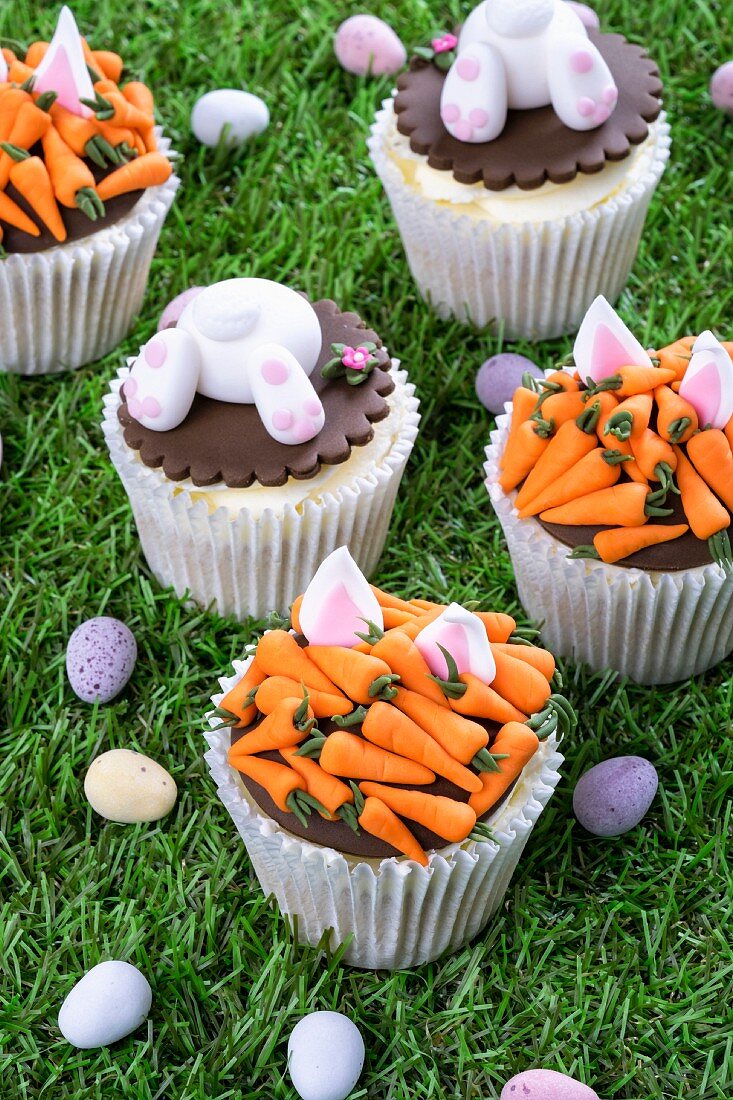 Various Easter cupcakes on a grass surface