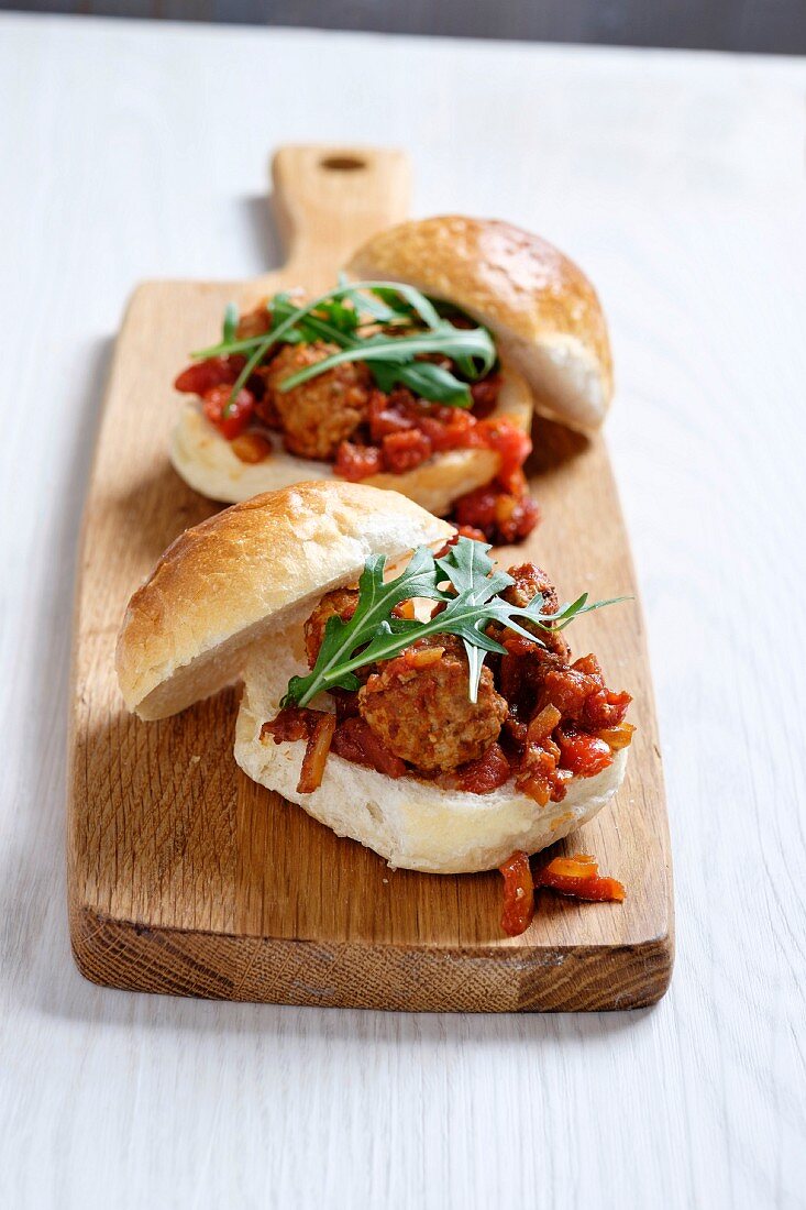 A turkey meatball sandwich with a tomato and onion sauce