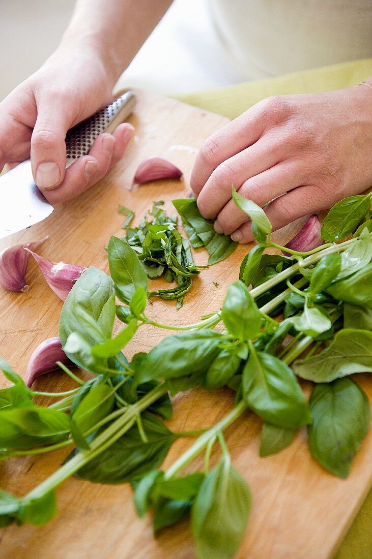 Basil and garlic being chopped