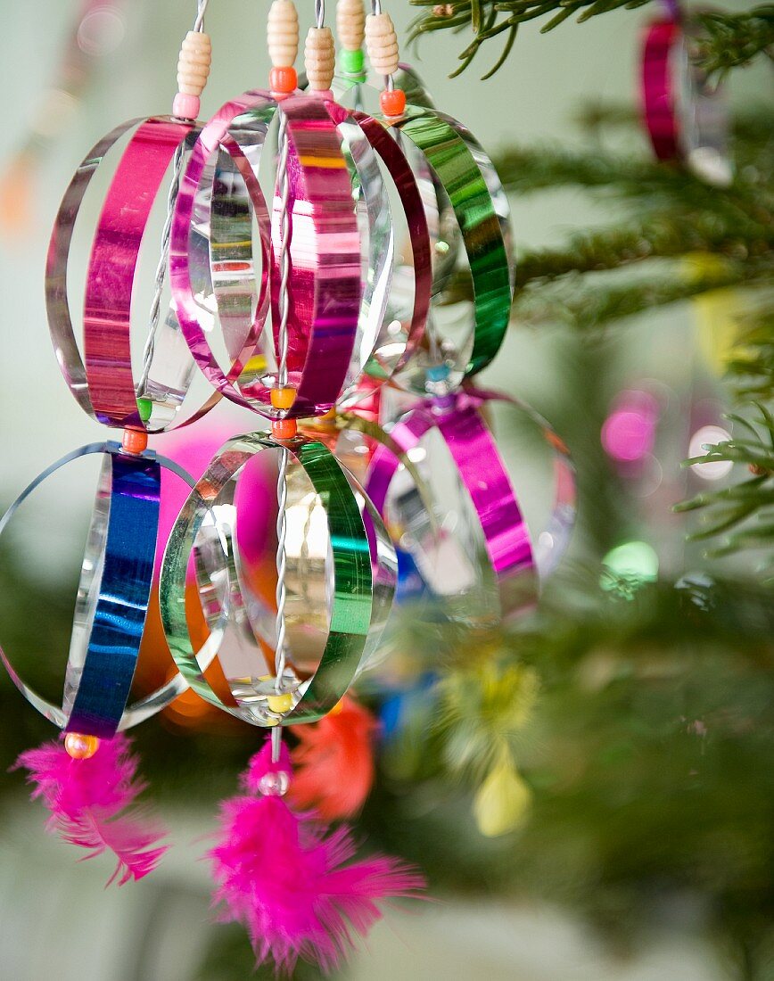 Colourful Christmas tree decorations made from shiny metal foil (close-up)