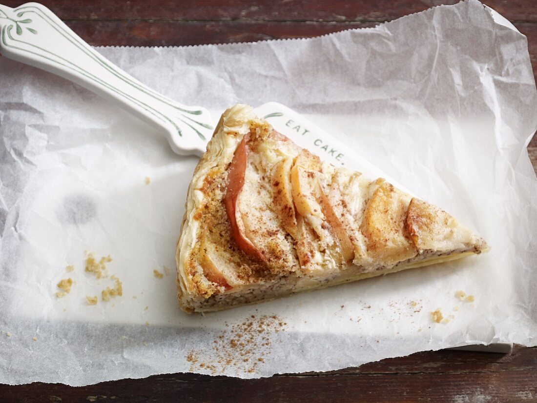 A slice of apple and quince tart on a cake slice