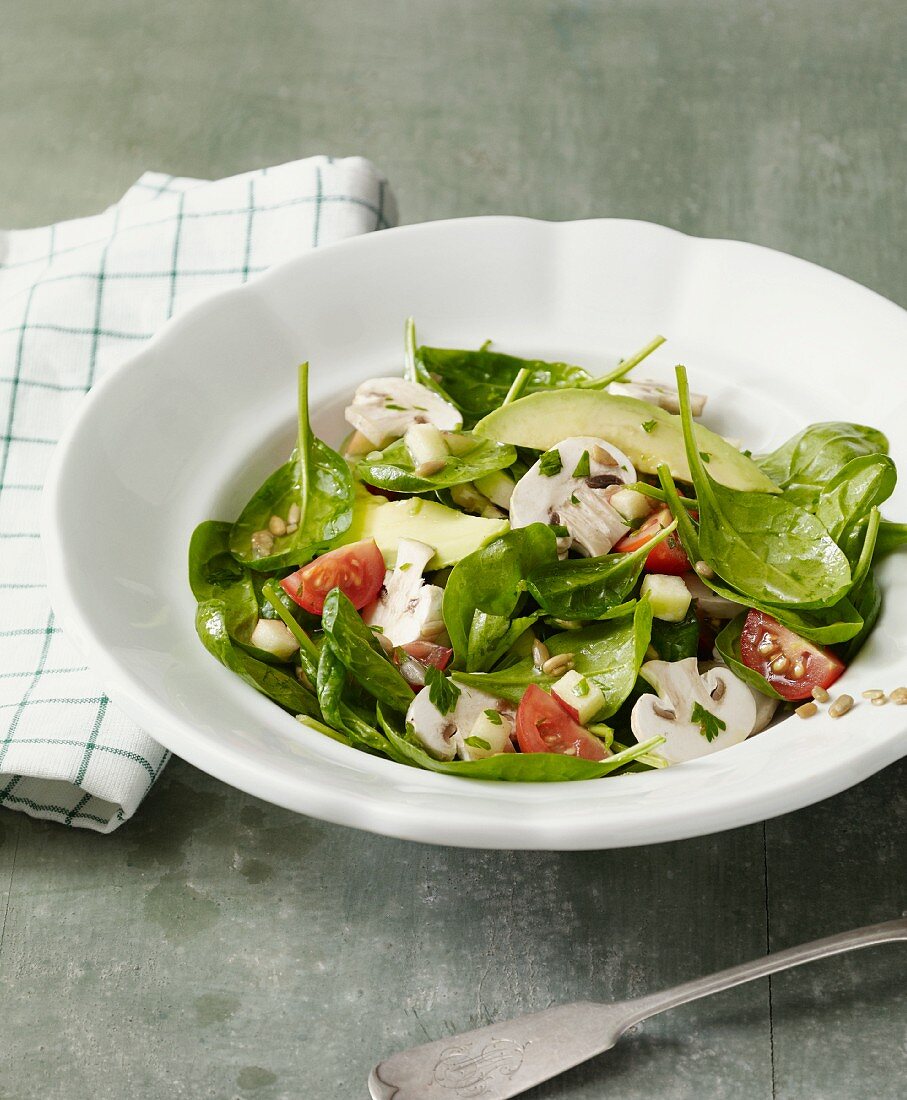 Spinach salad with mushrooms, avocado and cherry tomatoes