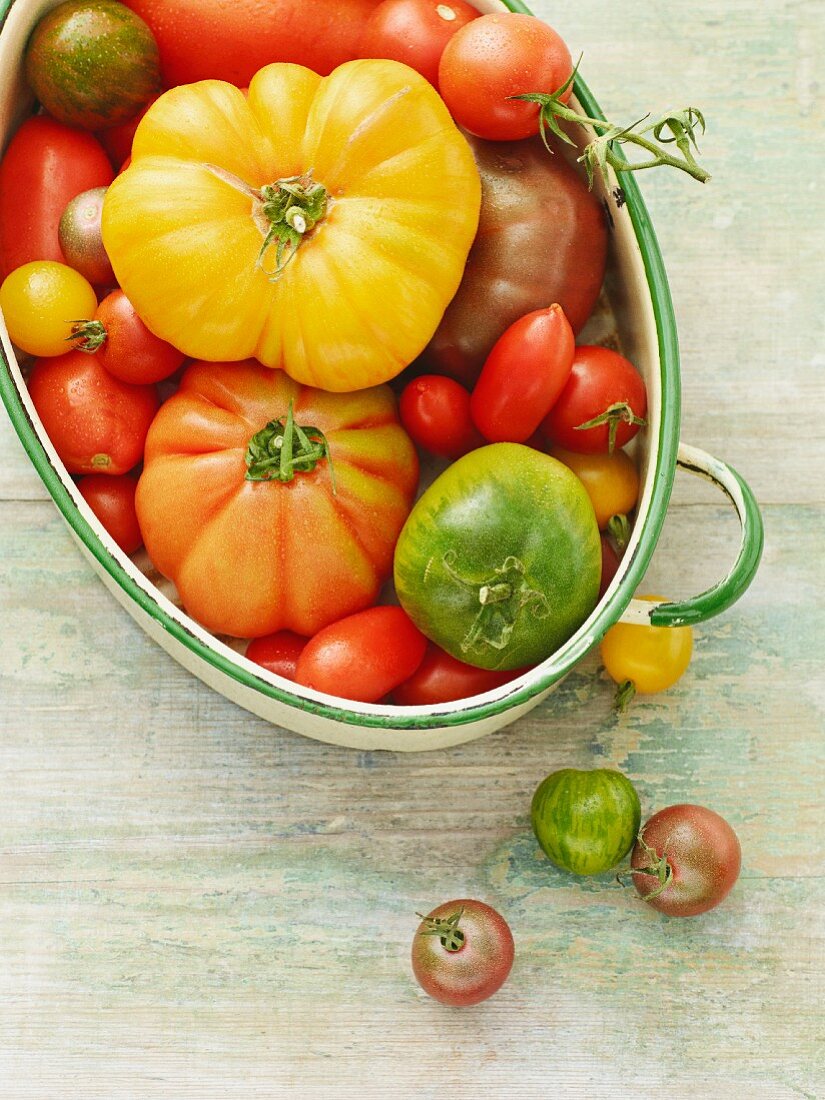 Various types of tomatoes in an oval dish