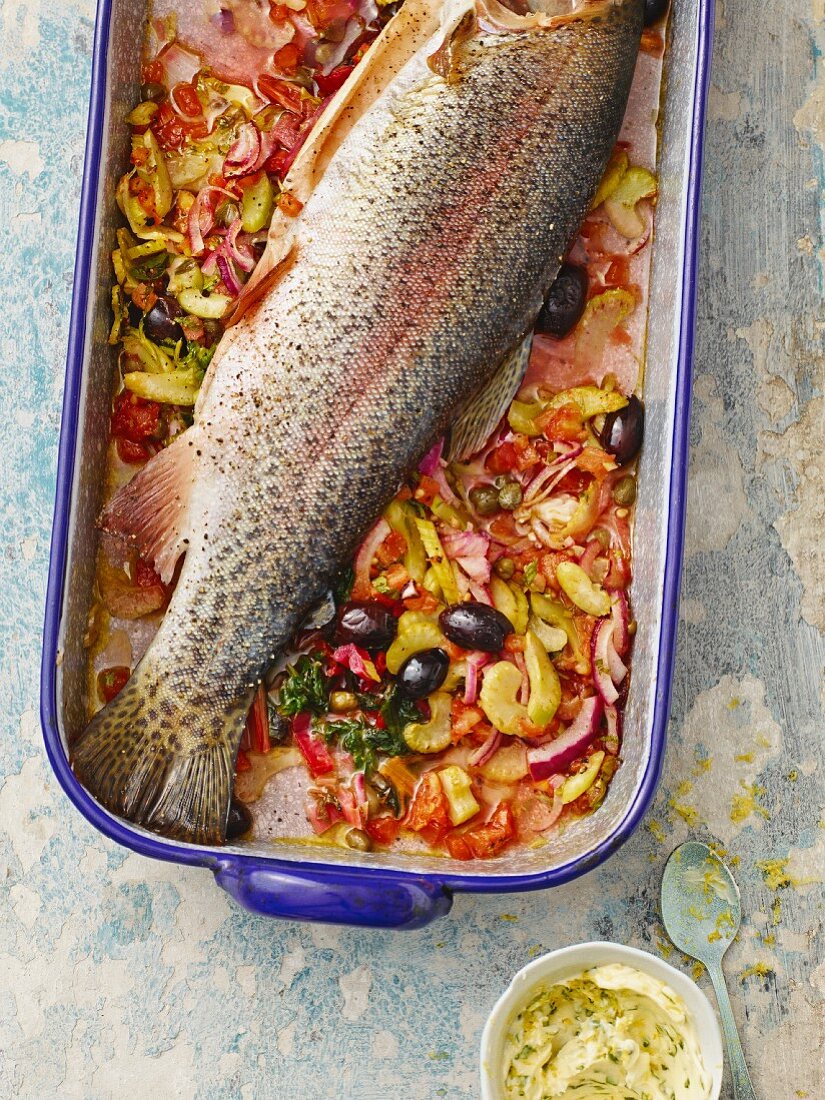 Oven-baked fish on a bed of chard with lemon butter