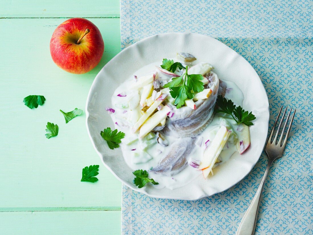 Soused herring in yoghurt cream with cucumber, apple and onion