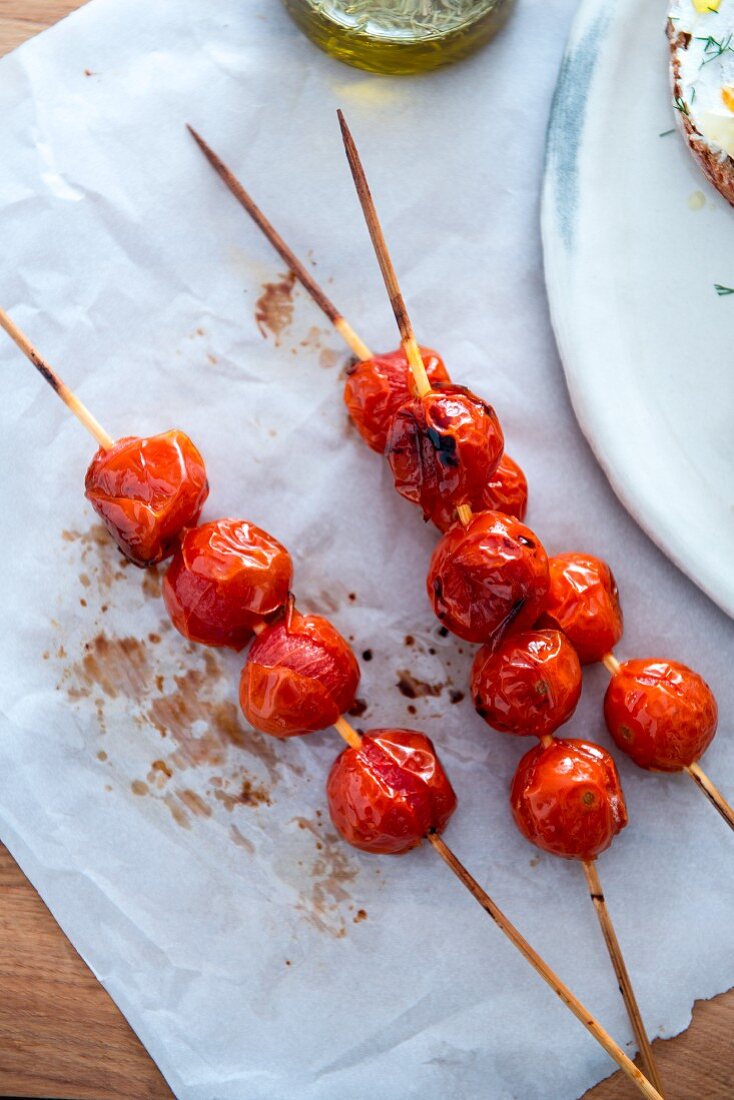 Roasted cherry tomatoes on wooden sticks