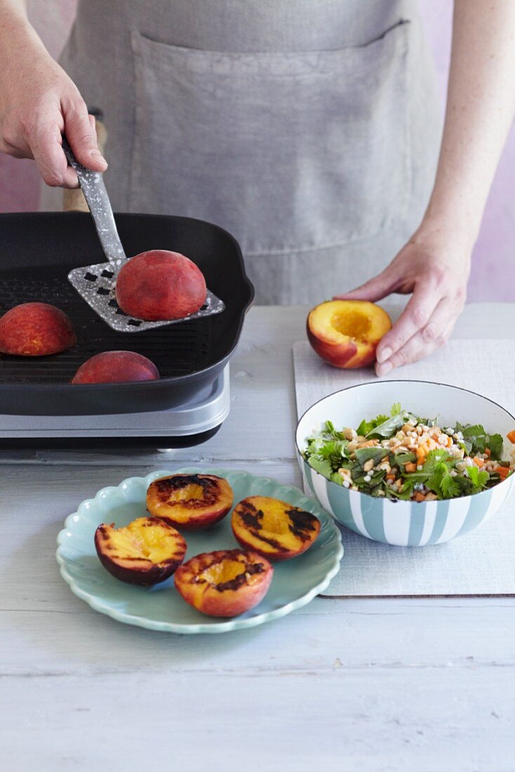 Peaches being grilled to be served with a barley salad