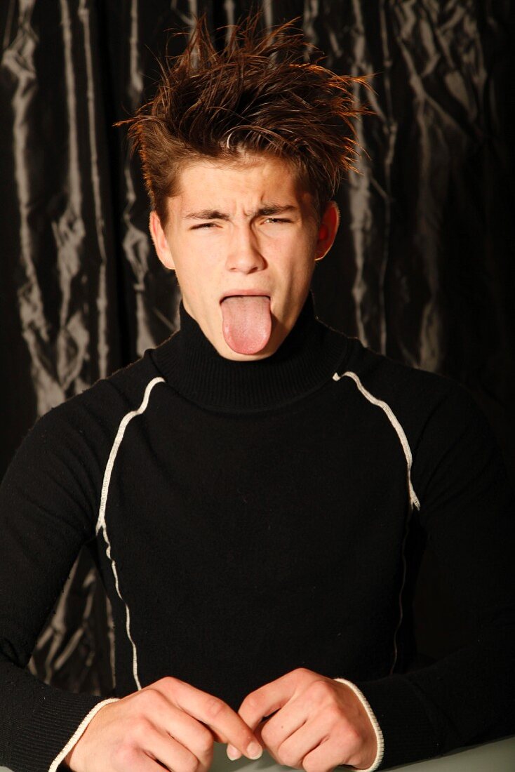 A young man sticking out his tongue – License image – 11343940 ❘ Image  Professionals