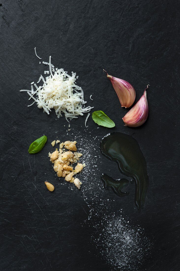 Pesto-Zutaten: Basilikum, geriebener Parmesan, Pinienkerne, Knoblauch, Olivenöl und Salz
