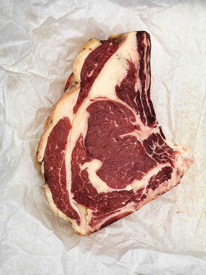 A beef steak on a piece of paper (seen from above)