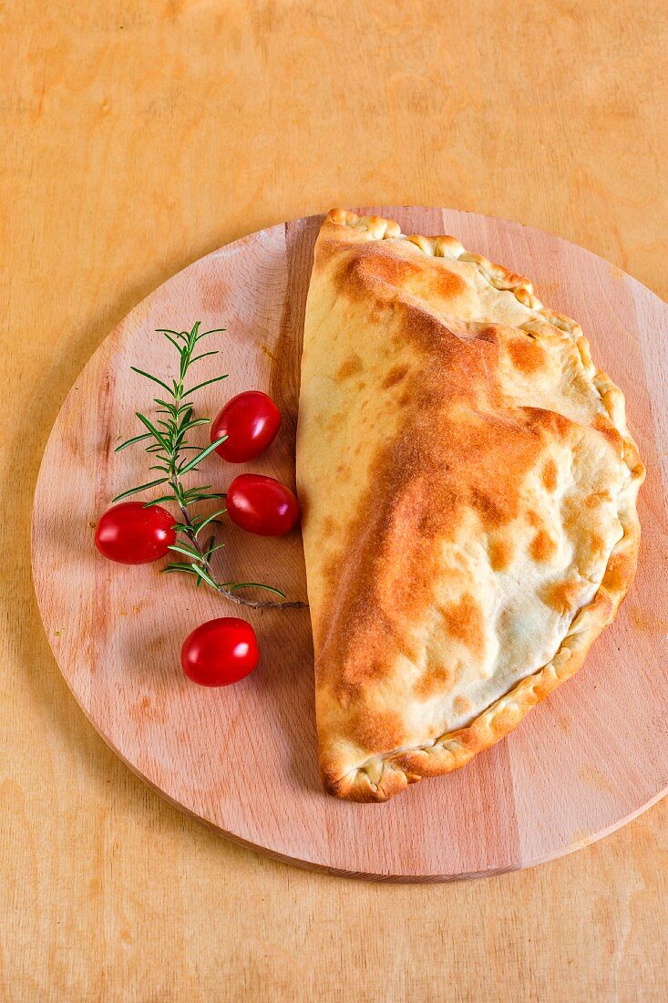 Calzone caprese (a pizza pocket filled with tomatoes and mozzarella, Italy)