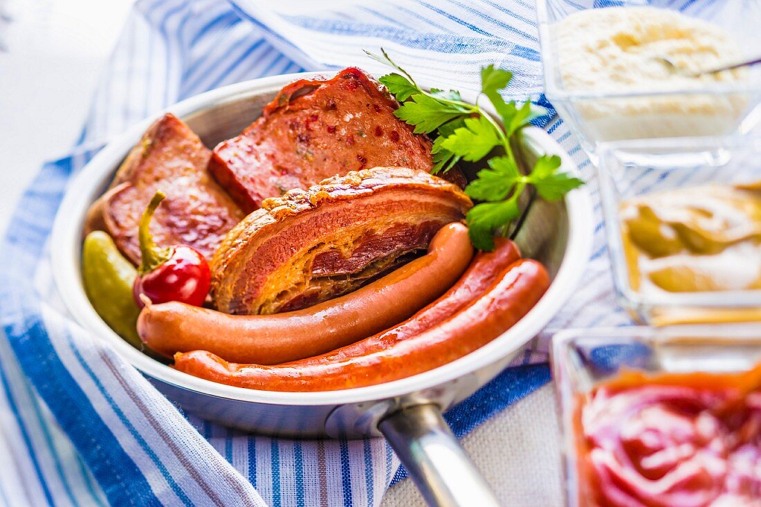 Frankfurter sausages, bacon and Leberkäse (beef and pork loaf) served with ketchup, mustard and horseradish