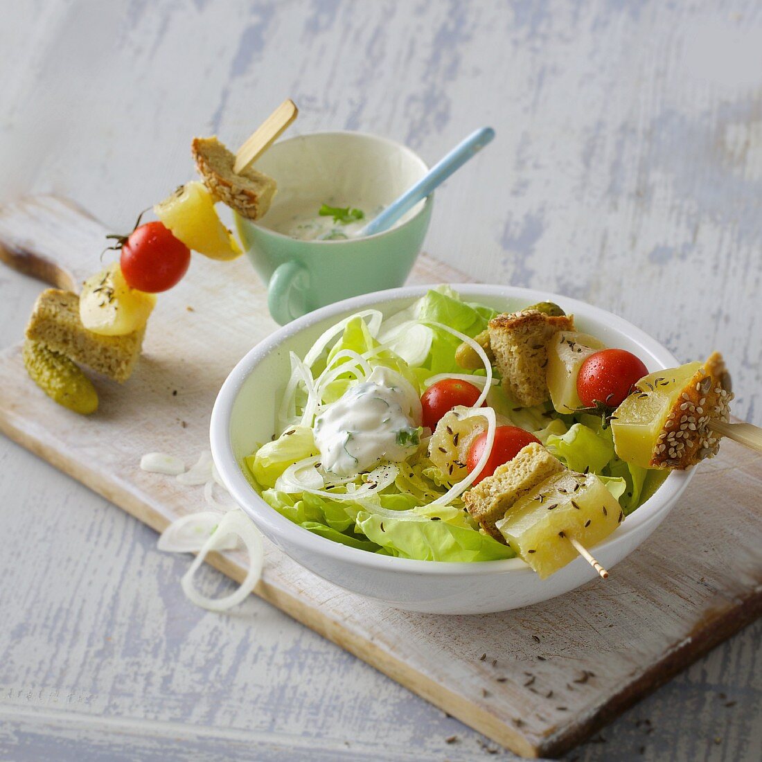 Harz cheese skewers with diced bread and fresh lettuce