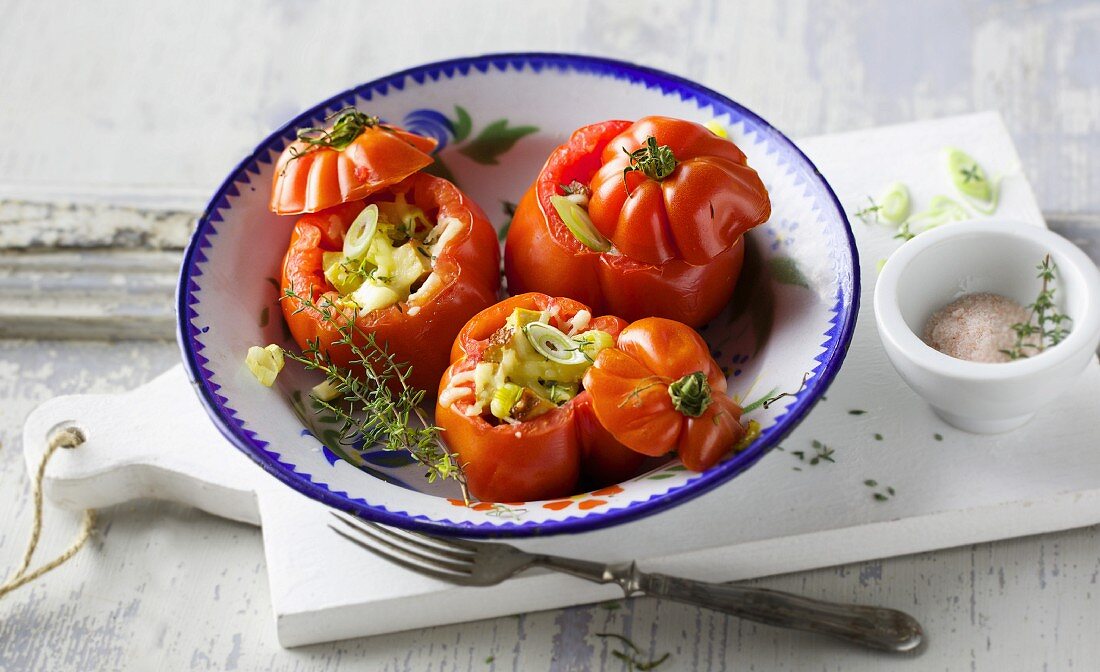 Stuffed, oven-roasted tomatoes with spring onions, tofu and cheese