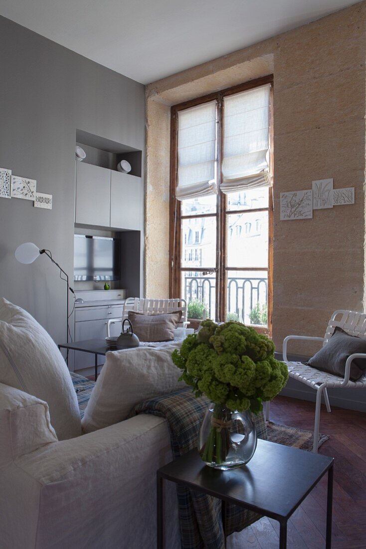 Living room with stone wall and period window