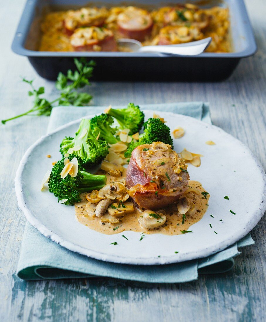 Pork fillet wrapped in ham with creamy mushrooms and almond broccoli