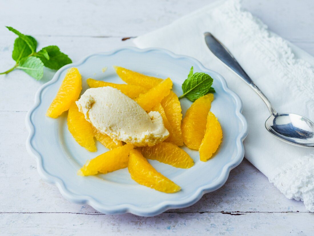 An almond and quark dumpling on a bed of filleted oranges