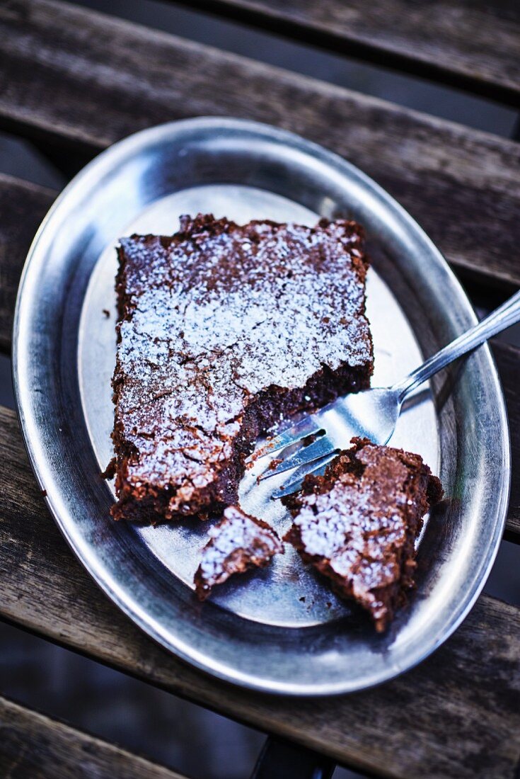 A brownie on a silver tray