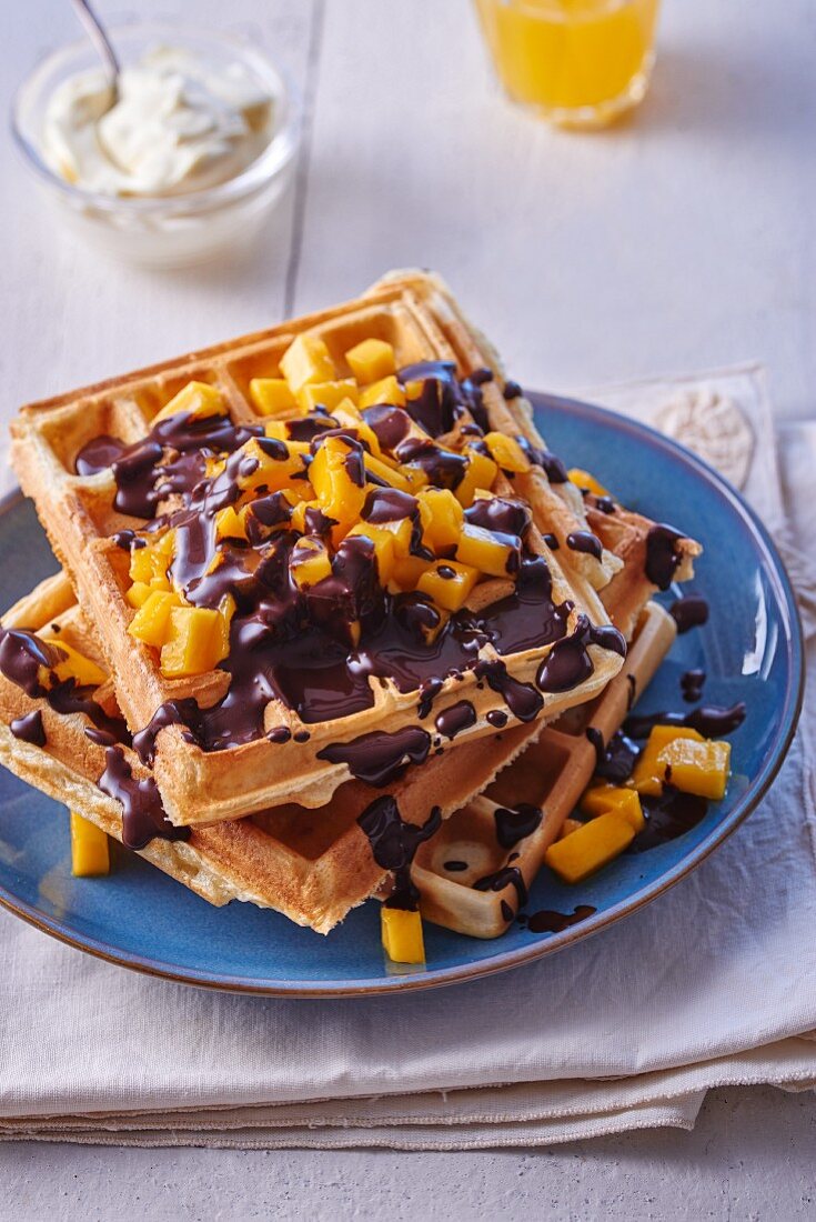 Waffles with chocolate sauce and diced mango