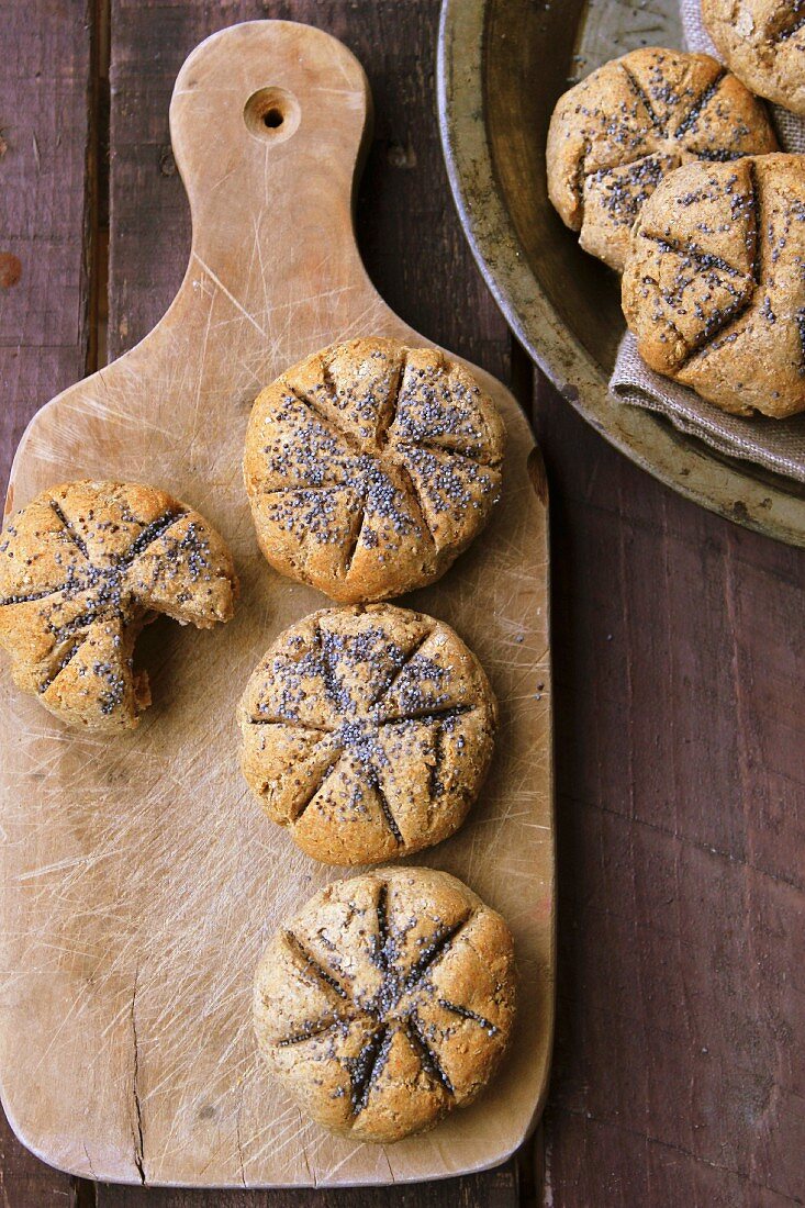 Rye bread rolls with poppy seeds on a chopping board