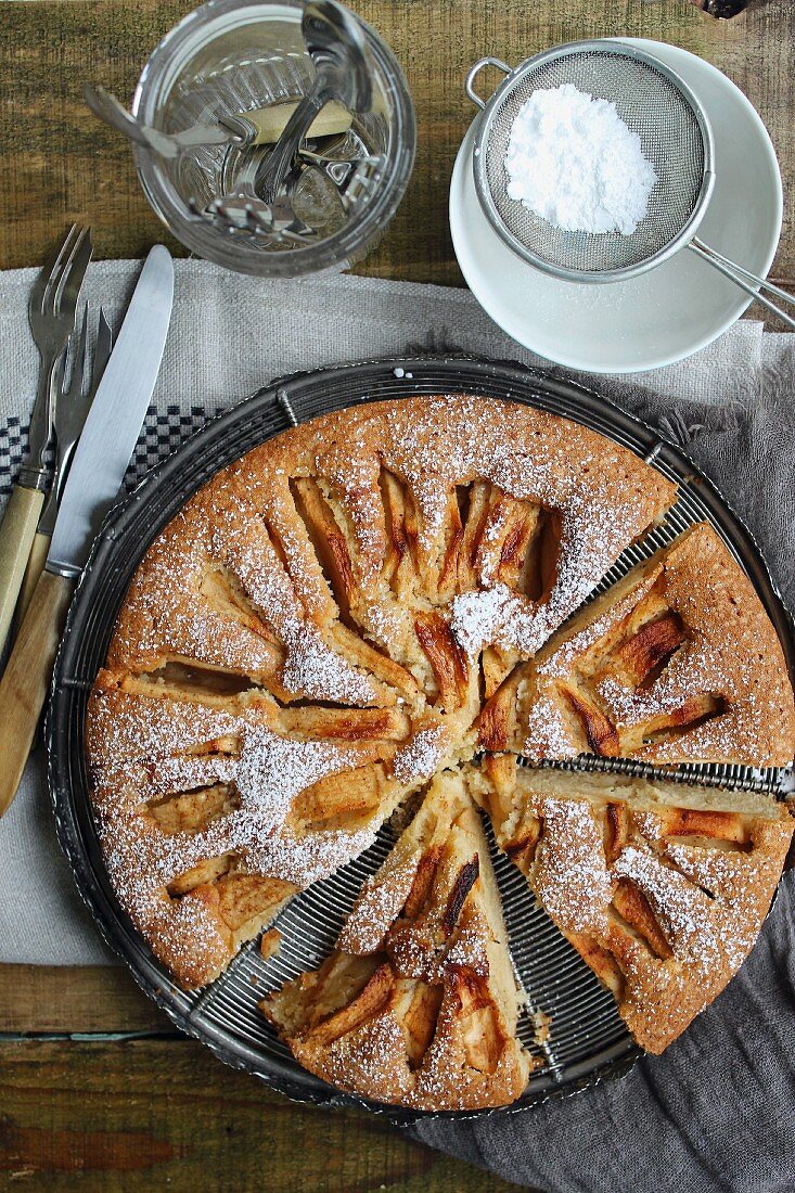 Apple cake with icing sugar, sliced