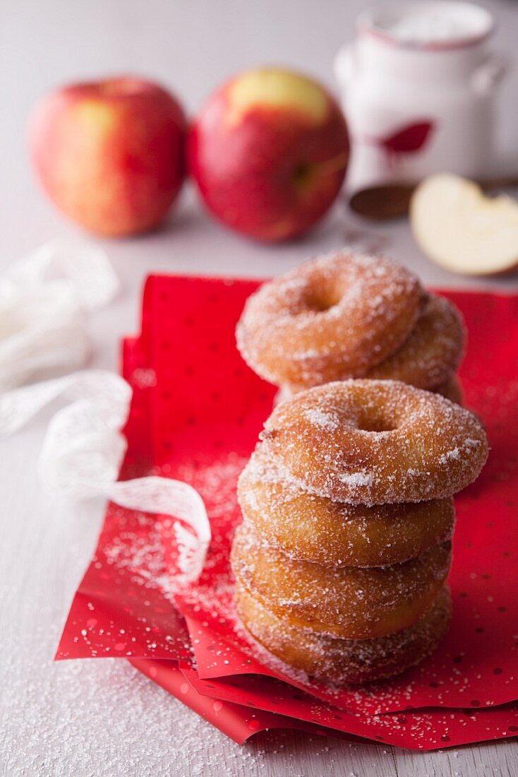 A stack of apple doughnuts with sugar